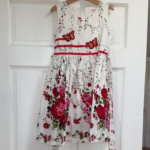 Charming White Dress with Red Floral and Butterfly Accents